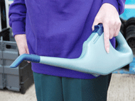 carry watering can close to body