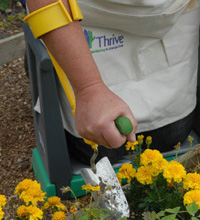 Trowel with fist grip and arm support