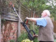 Telescopic battery powered hedge trimmer